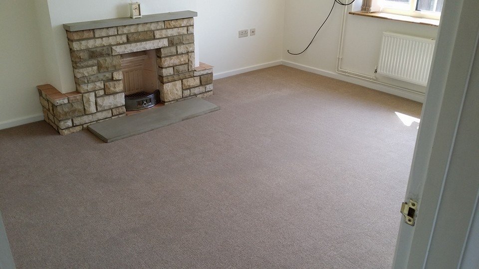 pale carpet fitted around fireplace