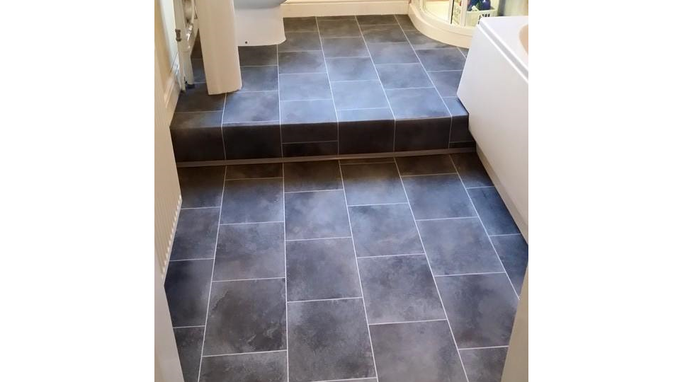 slate floor installed on stepped bathroom floor